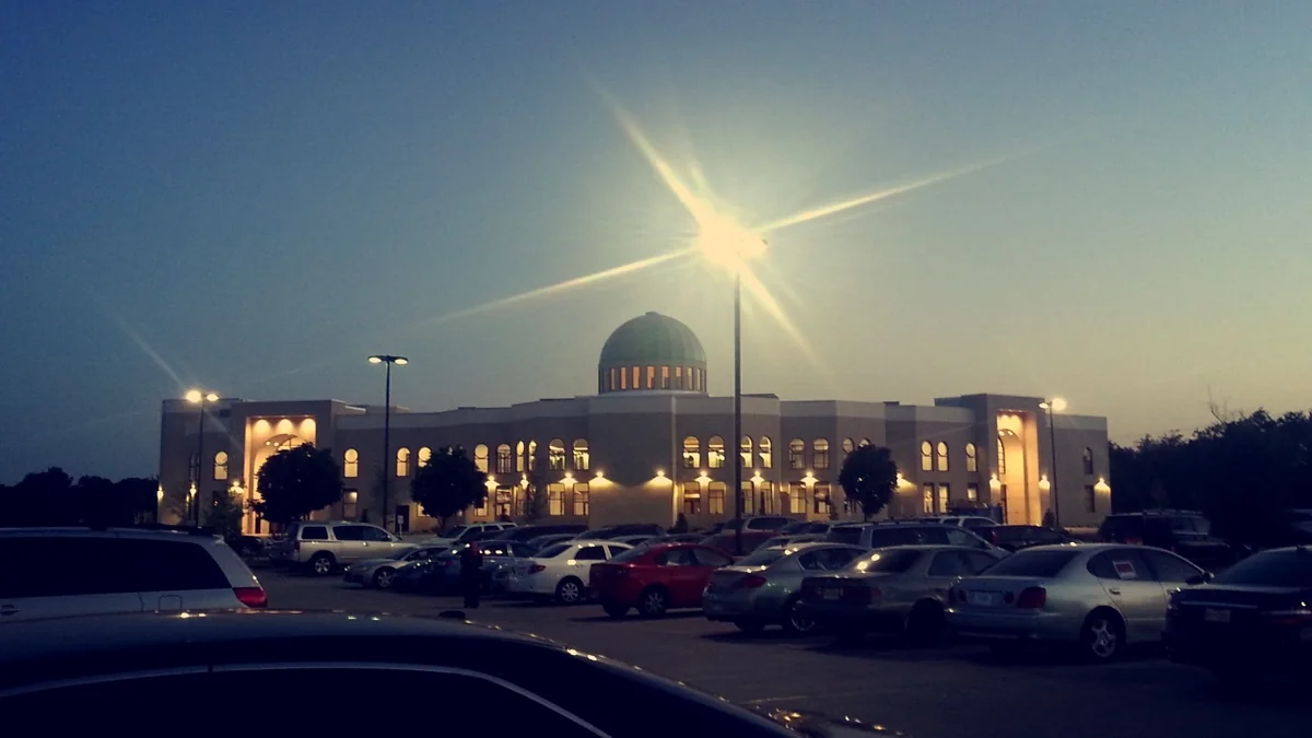 The East Plano Islamic Center building in Plano, Texas, with its arched entrance and dome visible from the road.
