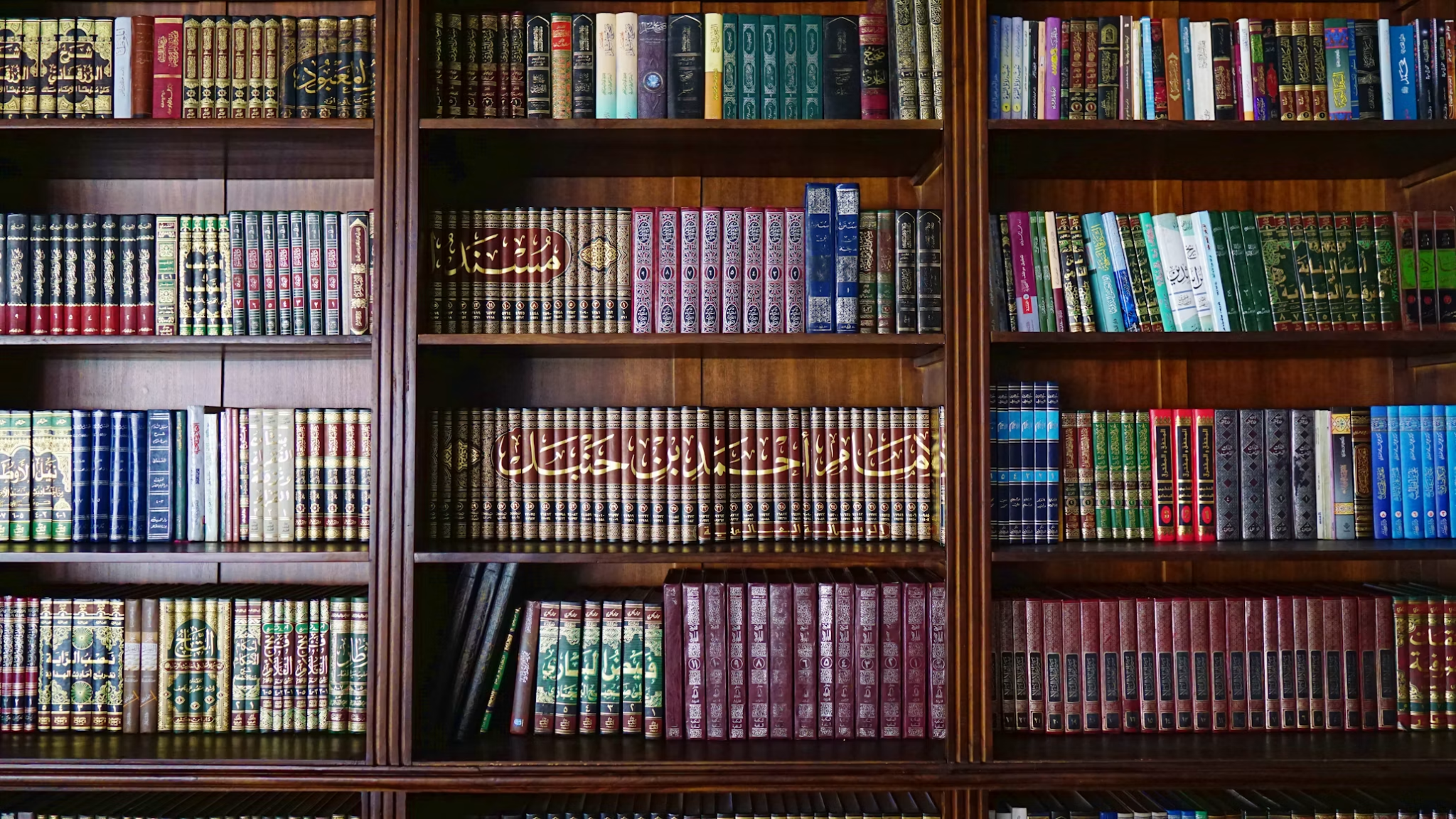 Shelves filled with Islamic books in Arabic and other languages.